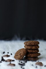 Chocolate and oats Cookies with chocolate chips and chocolate pieces on a white fur background