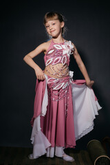 A little girl dressed as an belly dancer