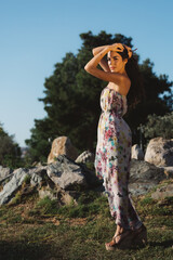 Girl in a dress posing in motion on a street background