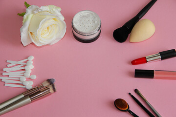 Obraz na płótnie Canvas everything for a makeup artist a set of cosmetics and makeup brushes on a pink background