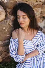 Portrait of young woman in a dress with closed eyes. 