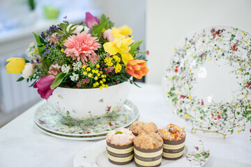 table setting with flowers and cakes  