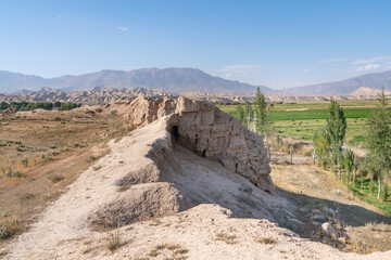 The view of old ancient ruined city Koshoy Korgon and the clay city wall in Kyrgyzstan