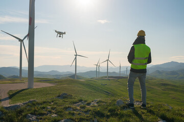 Technician Engineer in Wind Turbine Power Generator Station launches a drone for visual control of...