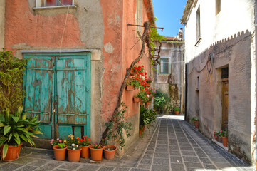 Fototapeta na wymiar A narrow street among the old houses of an ancient Italian town