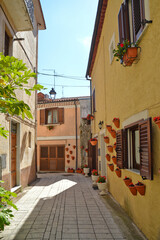 Fototapeta premium A narrow street among the old houses of an ancient Italian town