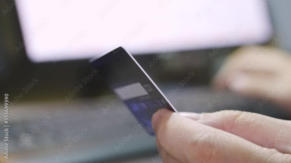 Poster close up shallow focus hand hold credit card and other hand key in keyboard. background for e-commer