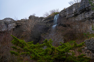 Waterfall On Eroded Limestone Cliff