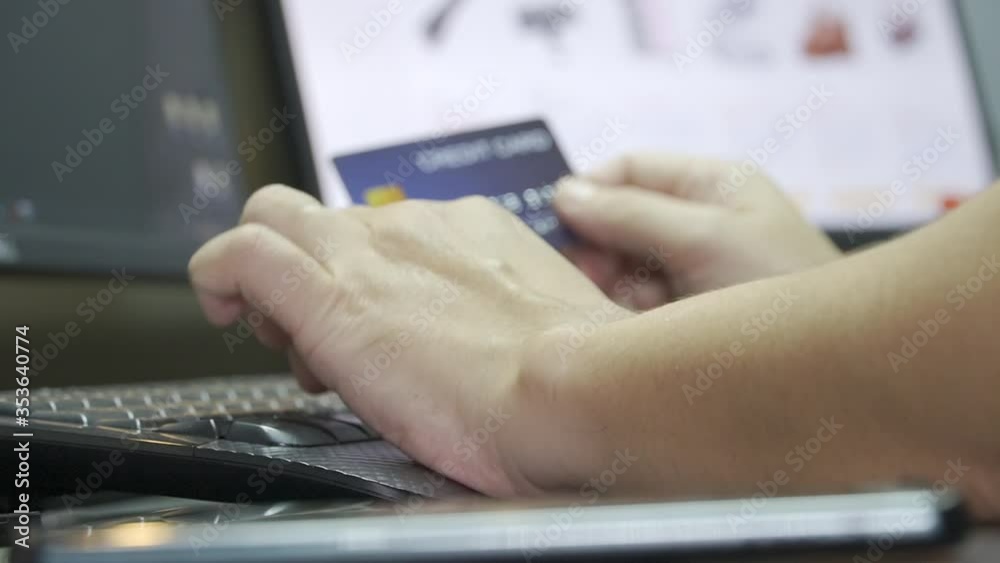 Poster close up shallow focus hand hold credit card and other hand key in keyboard. background for e-commer