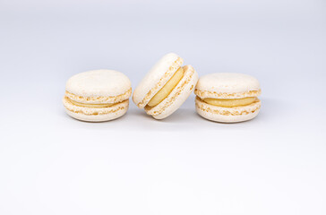 Sweet white french macaroons or macaron dessert isolated on white background. White cookies