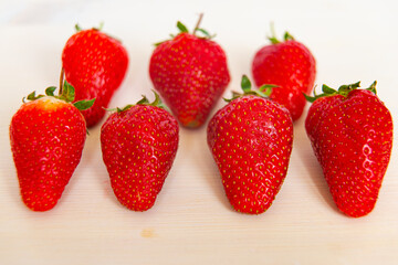 Ripe strawberries on wooden surface