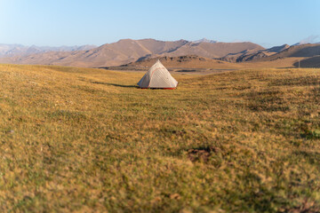 The amazing wild view of kyrgyzstan landscape full of snow peaks, wilderness and tent