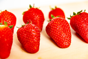 Ripe strawberries on wooden surface