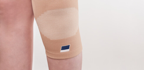 elastic bandage on knee, knee support for prevent healing injury. Injured leg in orthopedic bandage