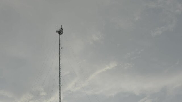 Tethered communication tower on cloudy sunset sky shot in blackmagic 6k raw