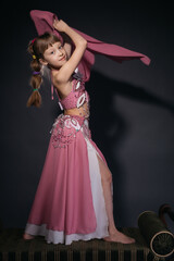 A little girl dressed as an belly dancer