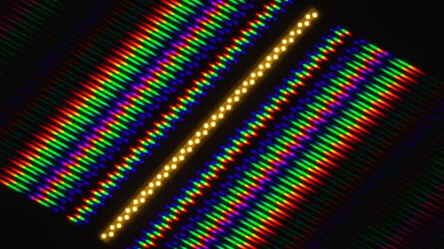 Beautiful bright and multi-color image of light diffraction from a rotating line of LEDs. Picture was obtained using a diffraction grating. LED emission spectrum illustration