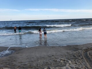 beach water sunset people