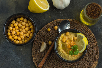 Hummus is a traditional appetizer made from chickpea puree the products it is made from are chickpeas, lemon, garlic and olive oil, horizontal arrangement