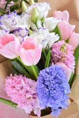 Beautiful elegant spring bouquet for greeting on pink background, selective focus, copy space. Bunch of tender tulips, eustoma flowers and hyacinthus. Romantic bouquet of flowers. Mother&rsquo;s Day