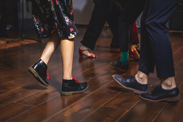 Dancing shoes of young couple dance retro jazz swing dances on a ballroom club wooden floor, close...