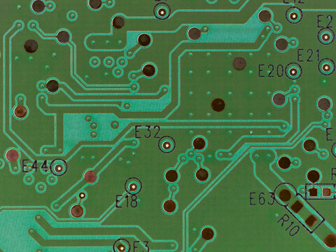 Green printed circuit board PCB hard drive. Fragment of printed wiring board PWB close up. Conductive pattern. IT&C. Background or wallpaper for theme computer hardware. Inverted image. Strong macro