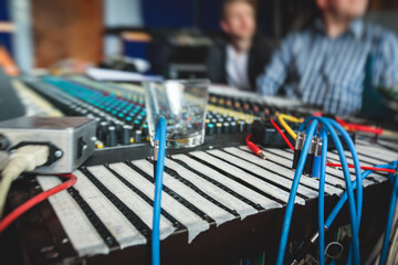 Sound editor engineer working at studio with mixing panel, mixing music and sound, stage sound...