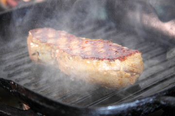 Grilling steak on a grill pan. Chef making steak. Beef tender steak on the grill pan. 