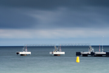 Harbor pier with cloudy sky on background