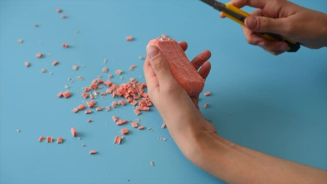 girl hands cuts the soap into small pieces