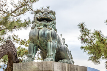 Fototapeta na wymiar Bronze lion guardian statue in Miyajima island, Japan