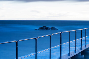Long exposure of an cloudy sunset over an jetty at Norderstrand on the island of Gotland in Sweden