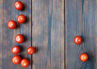 Red cherry tomatos on dark wooden boards