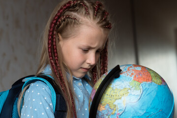 girl with globe at home. Home education concept
