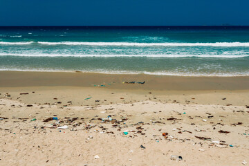 Plastic and other rubbish thrown on the sandy seashore, trash on the sea beach. ecological problem.  Dirty sandy beach