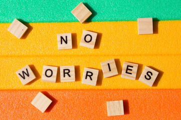 Words written on wooden blocks. Colorful background. No worries. Motivational message. Words and phrases. No worries writing