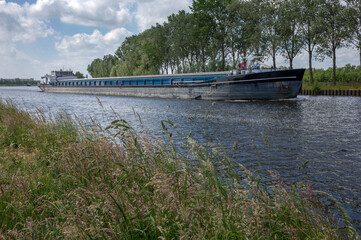 Fototapeta na wymiar Inland vessel. Barge at river. Canal. Beukers Netherlands. Hamingen. Zwartsluis. Meppeler Diep. Transport