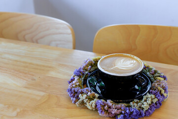 Latte coffee in a black glass