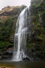 Fototapeta na wymiar Wli Waterfalls in the middle of the mountains in Ghana.