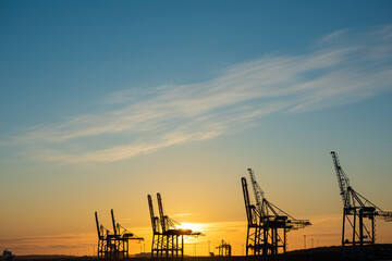 Ship to shore container cranes at sunset