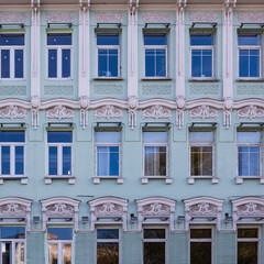 Obraz premium Vintage architecture classical green facade white stucco molding front view.