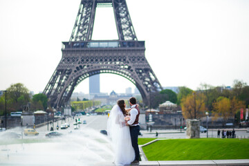 Obraz premium wedding couple. The bride in a beautiful wedding dress, the bride in a stylish tuxedo, Paris France