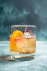 Old fashioned beverage with orange slices on rustic background. Selective focus. Shallow depth of field.