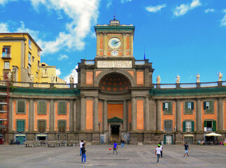Children plays soccer in front Vittorio Emanuele II National Boarding School, historical and religious complex in Naples in Dante Square, Italy 