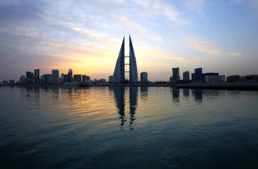 MANAMA, BAHRAIN - FEBRUARY 23: The Bahrain World Trade Center during sunrise, a twin tower complex is the first skyscraper in the world to have wind turbines, February 23, 2018, Manama, Bahrain