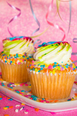 Cupcake pastry decorated with festive sprinkles and sugar frosting at a sparkly holiday celebration