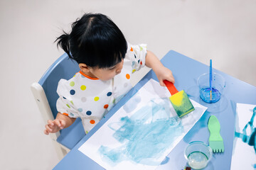 Asian toddler girl is painting water color. toddler activity at home. - 353655528
