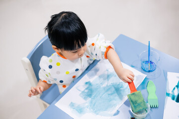 Asian toddler girl is painting water color. toddler activity at home. - 353655543