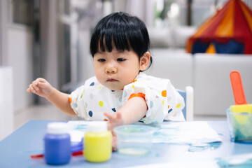 Asian toddler girl is painting water color. toddler activity at home. - 353655573