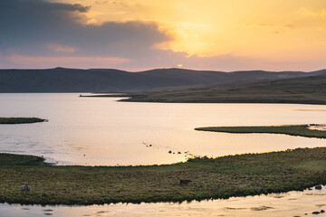 Obraz premium Beautiful Sunset On The Mountain Lake WIth The Little Island Inside